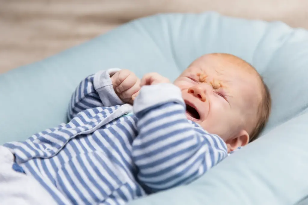 crying red haired baby blue grey clothes 1